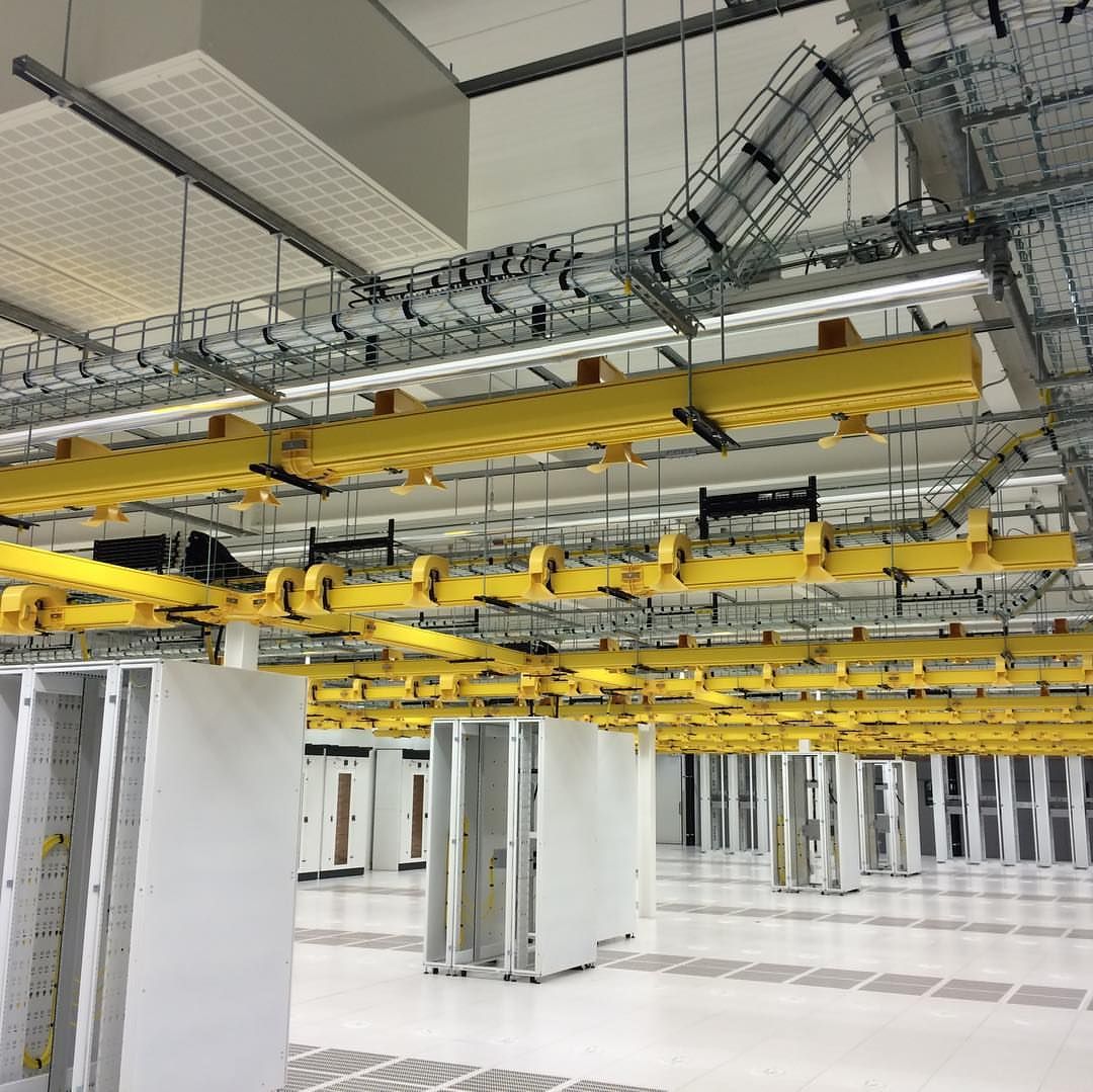 The yellow fiber troughs and wire wesh cable tray used in American data centers
